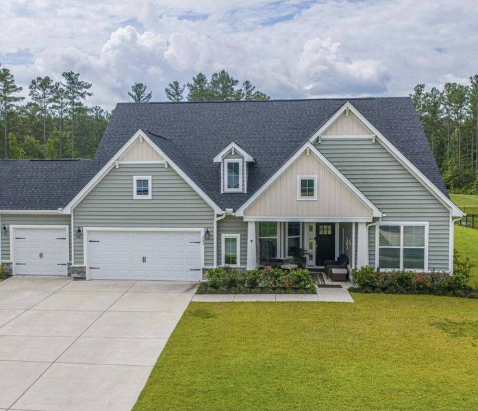 Front exterior of a new home in The Enclave at French Quarter Creek, Huger, SC, highlighting curb appeal (Image 2). Front exterior of a new home in The Enclave at French Quarter Creek, Huger, SC, highlighting curb appeal (Image 2).