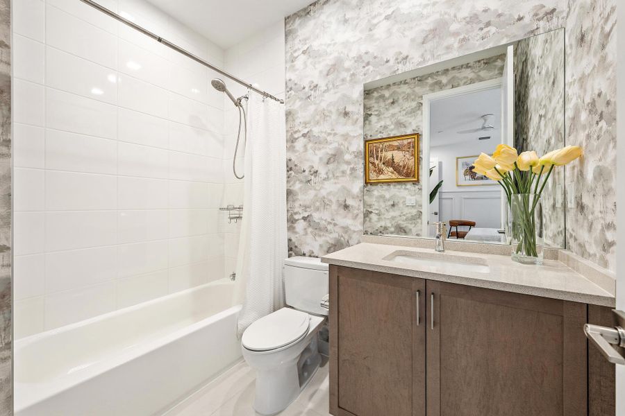 Upgraded vanity, tile, and designer wallpaper.