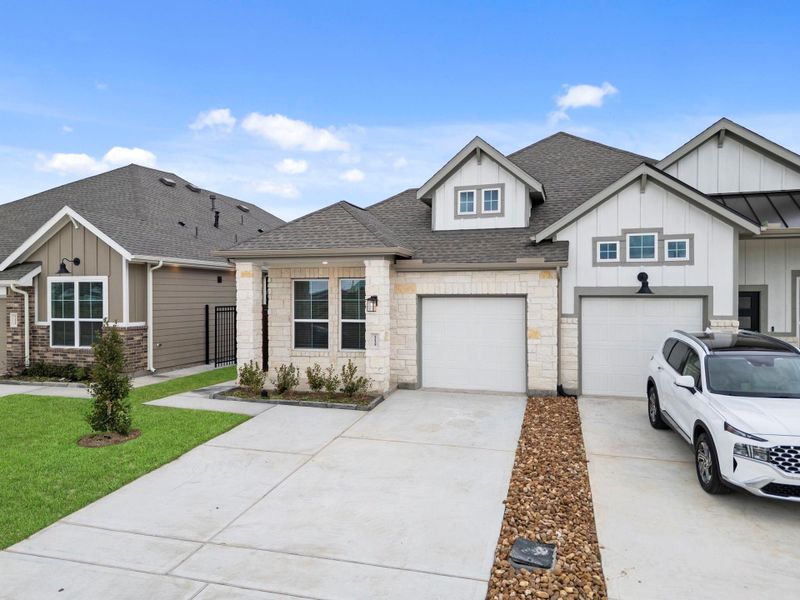 Front exterior of a new home in Meridiana, Manvel, TX, highlighting curb appeal (Image 17).