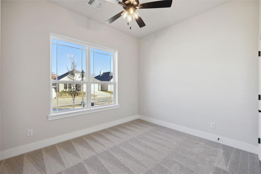 Unfurnished room featuring ceiling fan and light colored carpet