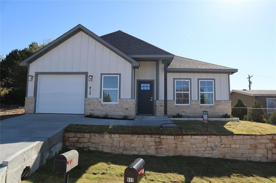 View of Front of House with a step yard and garage