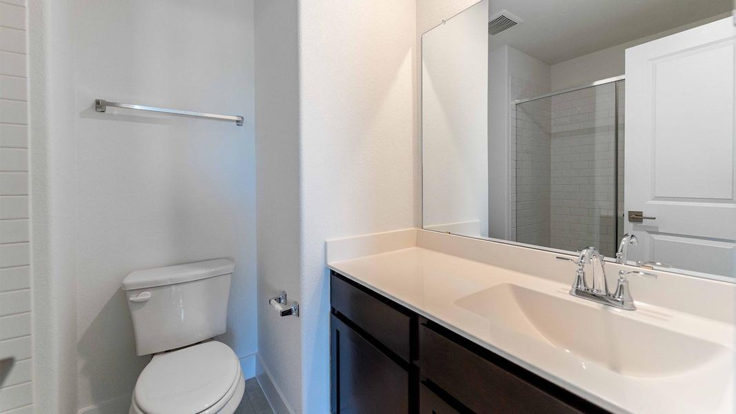 Full bathroom featuring vanity and a stall shower Full bathroom featuring vanity and a stall shower