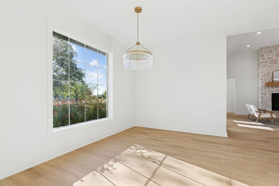 Lovely dining room with views of the backyard and the rose bushes just beyond the window.
