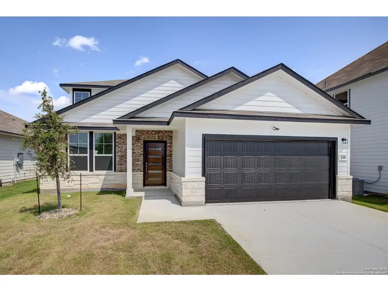 Front exterior of a new home in Hannah Heights, Seguin, TX, highlighting curb appeal (Image 1).