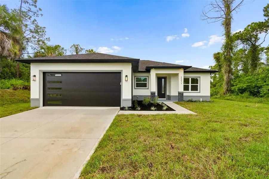 Front exterior of a new home in , North Port, FL, highlighting curb appeal (Image 1). Front exterior of a new home in , North Port, FL, highlighting curb appeal (Image 1).