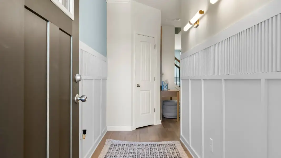 Inviting entryway of new construction townhome featuring stylish trim and modern entry design. Inviting entryway of new construction townhome featuring stylish trim and modern entry design.