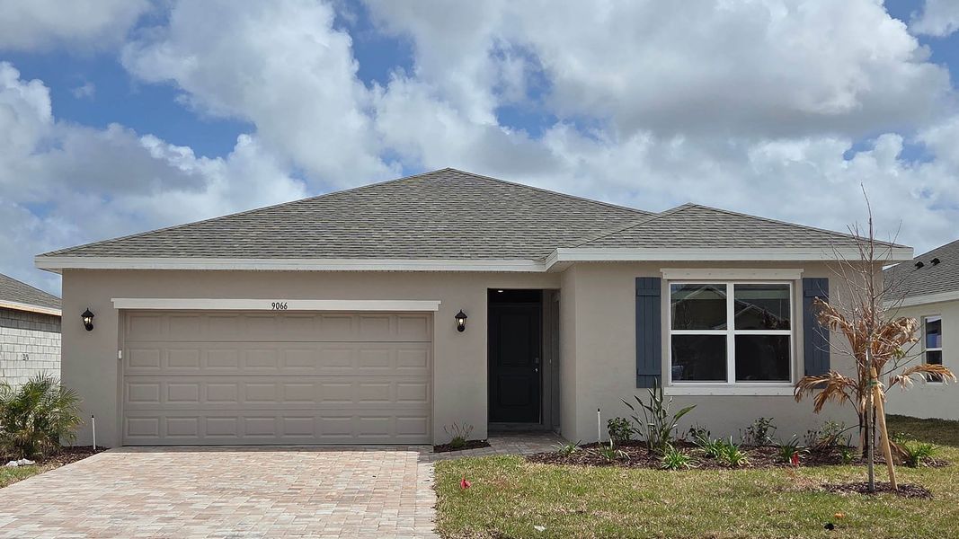 Front exterior of a new home in Venetian Grove, Vero Beach, FL, highlighting curb appeal (Image 1). Front exterior of a new home in Venetian Grove, Vero Beach, FL, highlighting curb appeal (Image 1).