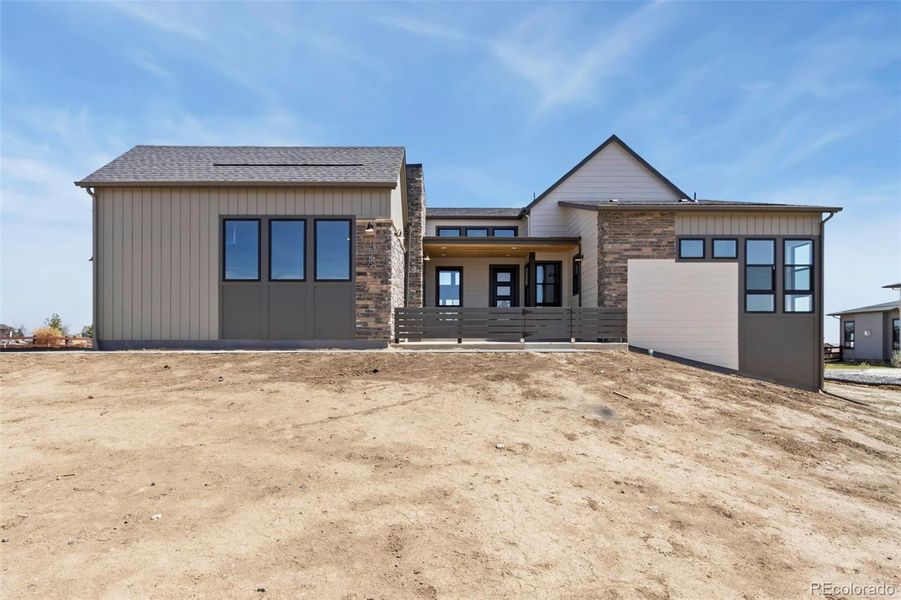 Front exterior of a home in the Acadia at RainDance community, located in Windsor, CO (Image 5).