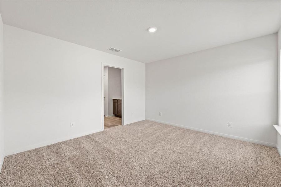 Unfurnished room featuring light colored carpet