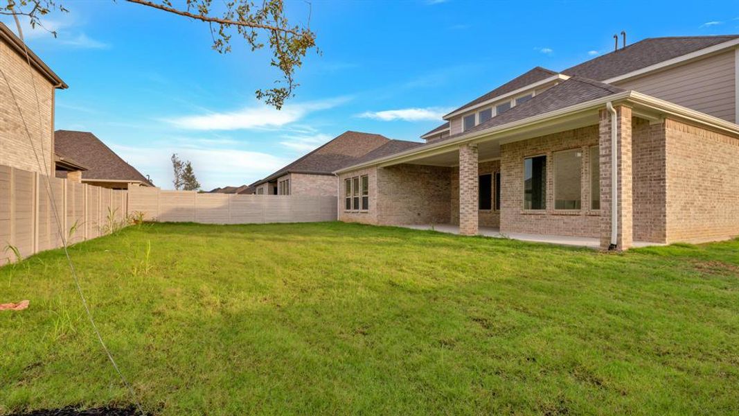 Rear view of property featuring a yard