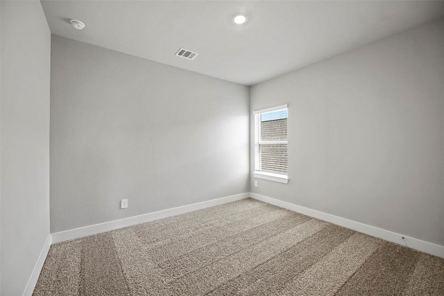 Three spacious secondary bedrooms upstairs, each with large closets and cozy carpet underfoot.