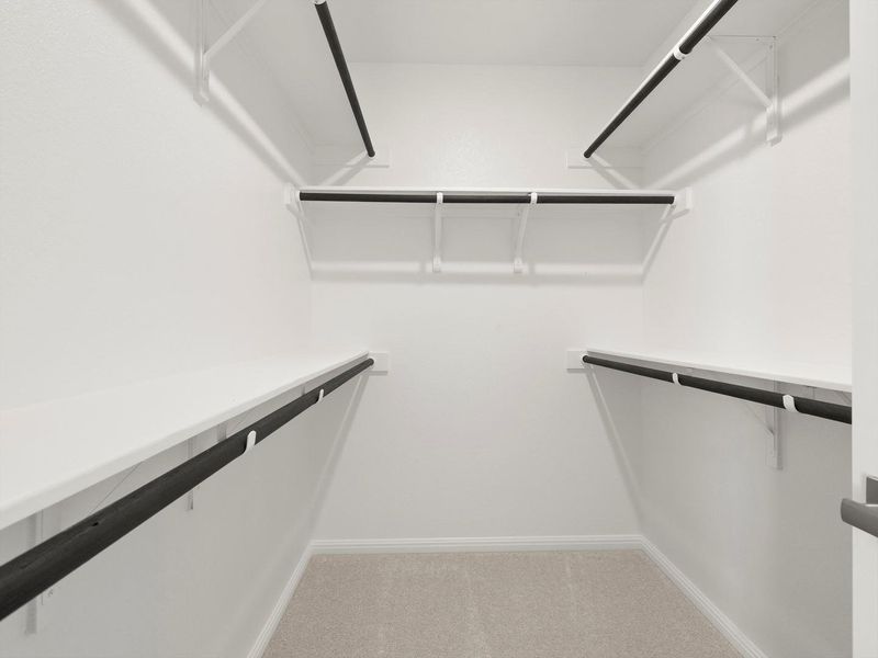 An organized walk-in closet with ample shelving and hanging space for effortless storage.