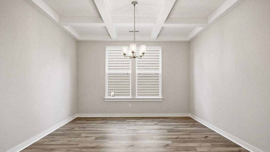 Dining Room with two windows, chandelier, coffered ceiling trim, and hard surface flooring Dining Room with two windows, chandelier, coffered ceiling trim, and hard surface flooring