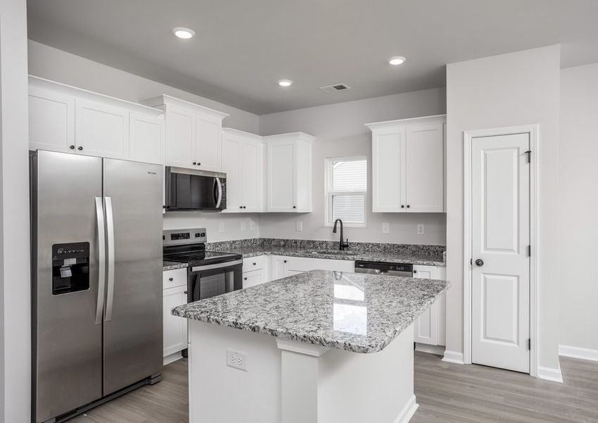 The kitchen has designer wood cabinetry