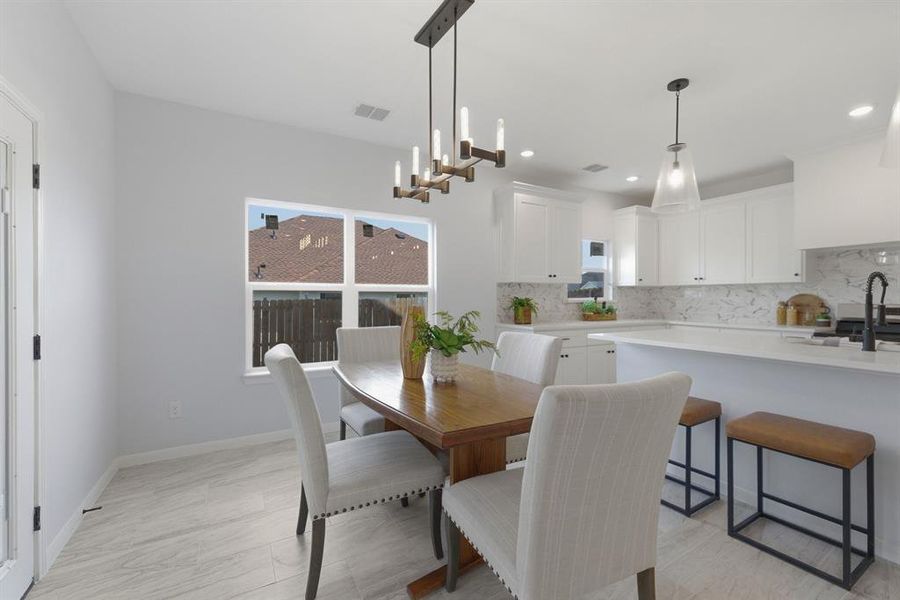 Dining room with baseboards and suspended lighting Dining room with baseboards and suspended lighting