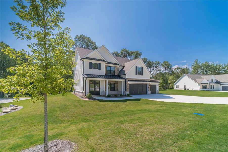 Front exterior of a new home in , Loganville, GA, highlighting curb appeal (Image 26).