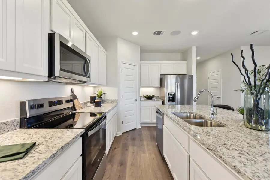 Culinary delights await in this bright kitchen with ample counter space and modern appliances.