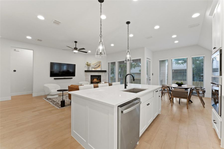Open-concept living space with light wood-finish flooring