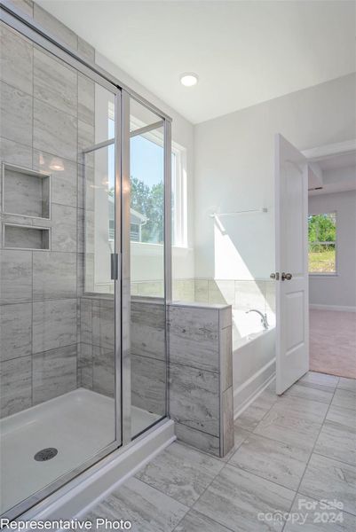 This home will feature a Luxury Primary Shower with tile walls and sem-frameless shower door