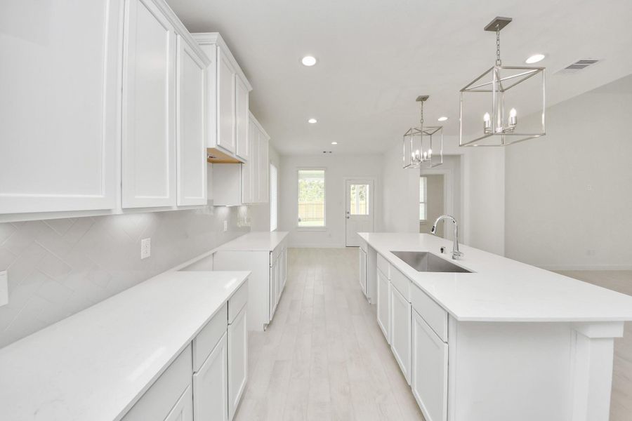 This kitchen is truly a chef's dream! This haven Boasts high ceilings, recessed & pendant lighting, stained wood cabinets, granite countertops, stainless steel appliances, a modern tile backsplash. All of this overlooks your expansive family room, creating a perfect space for culinary delights and family gatherings. This kitchen is truly a chef's dream! This haven Boasts high ceilings, recessed & pendant lighting, stained wood cabinets, granite countertops, stainless steel appliances, a modern tile backsplash. All of this overlooks your expansive family room, creating a perfect space for culinary delights and family gatherings.
