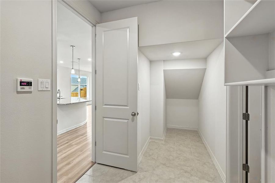 Corridor featuring baseboards and recessed lighting