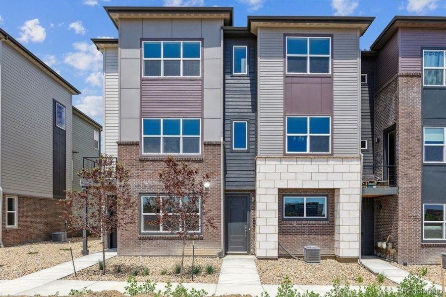 Front exterior of a new home in Townhome Collection at Grand Vue at Interlocken, Broomfield, CO, highlighting curb appeal (Image 15).