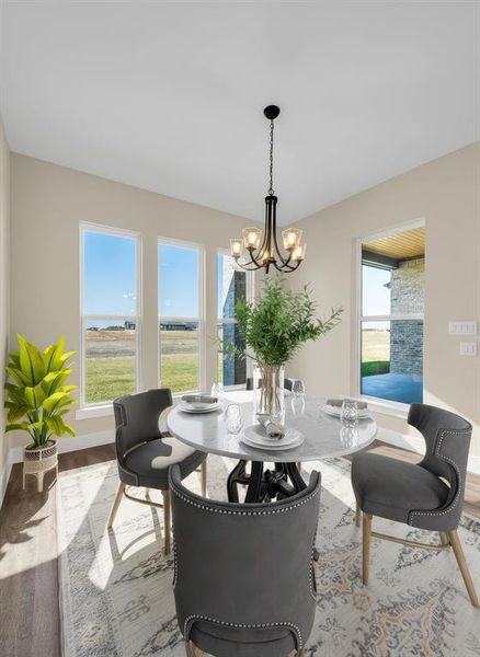 Stage Dining space featuring light wood finished floors and a chandelier Stage Dining space featuring light wood finished floors and a chandelier