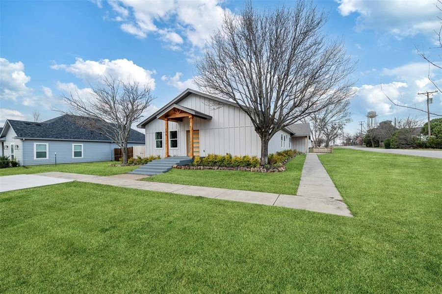 View of front of home featuring a front yard and board and batten siding