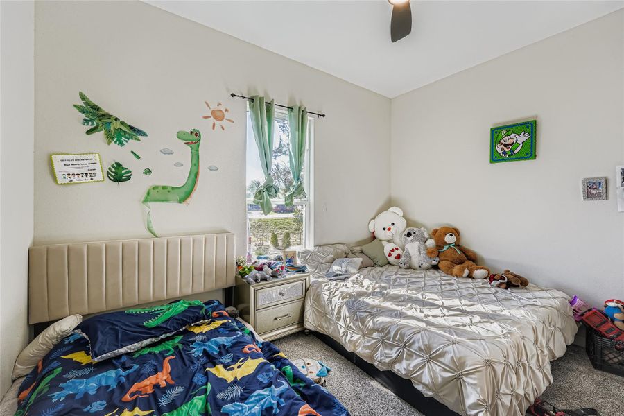 Bedroom featuring carpet flooring and ceiling fan Bedroom featuring carpet flooring and ceiling fan