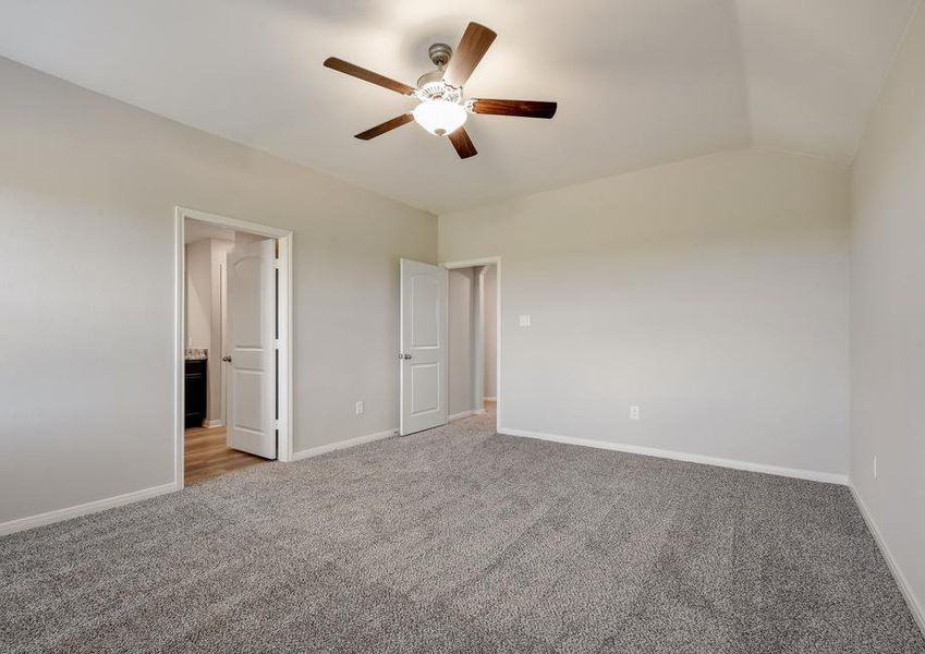 Master bedroom with an attached bathroom and walk-in closet.