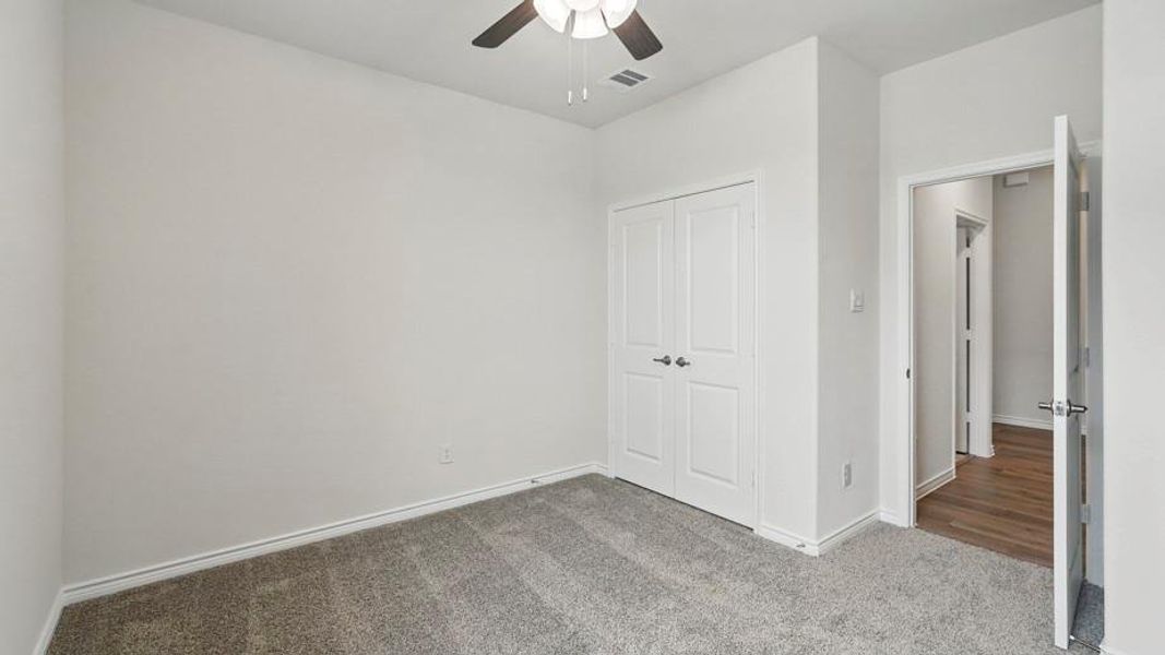 Neutral tone walls and grey carpet flooring