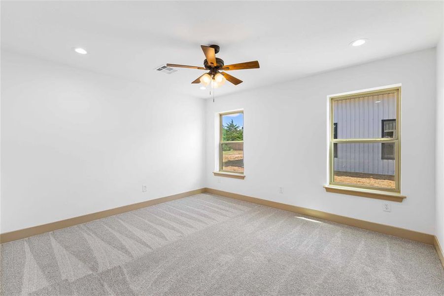 Empty room with light carpet, recessed lighting, and a ceiling fan