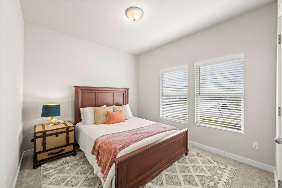 A well-lit bedroom offering a cozy retreat with ample natural light. A well-lit bedroom offering a cozy retreat with ample natural light.