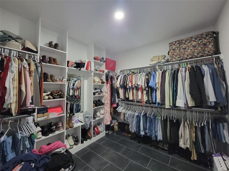 Primary Bdrm Walk in closet featuring dark tile patterned floors