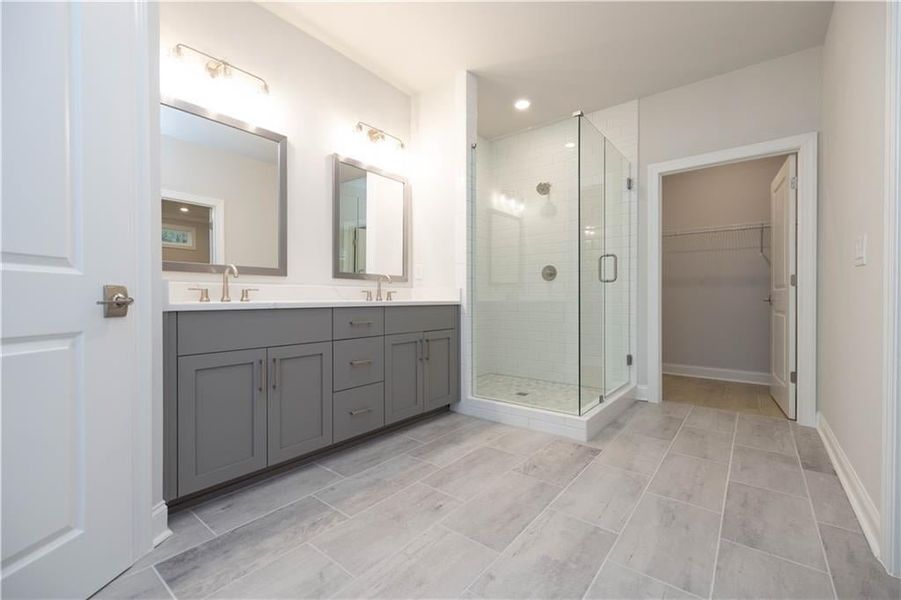 And a beautiful frameless walk in shower. *Please note photos shown are of the Ellington plan but not of the actual home.
