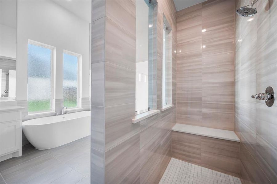 Bathroom featuring vanity, tile walls, separate shower and tub, and tile patterned flooring