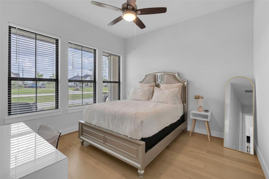 Comfortable guest bedroom with abundant natural light.