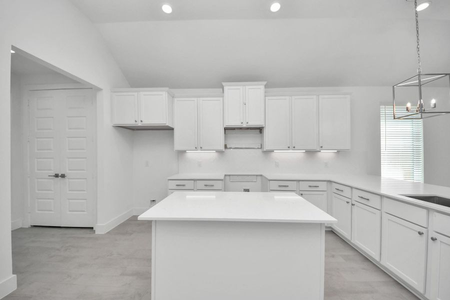 This kitchen is by far any chef’s dream! This spacious kitchen features high ceilings, light stained wood cabinets, granite countertop, SS appliances, modern tile backsplash, recessed lighting, extended counter space, granite kitchen island, and space for breakfast bar, and a walk-in pantry all overlooking your huge family room.