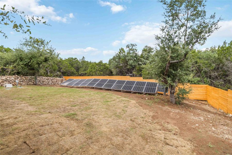 View of solar panels and back fence