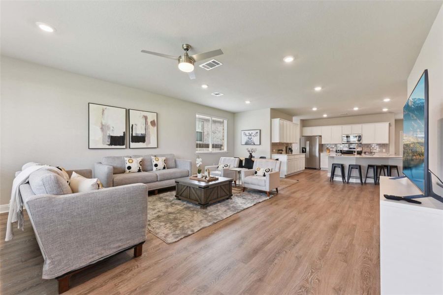 Living area featuring recessed lighting, ceiling fan, and light wood-style flooring Living area featuring recessed lighting, ceiling fan, and light wood-style flooring