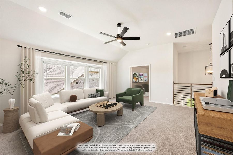 Upstairs living area with vaulted ceiling, ceiling fan, carpet flooring, and large windows overlooking neighboring homes Upstairs living area with vaulted ceiling, ceiling fan, carpet flooring, and large windows overlooking neighboring homes