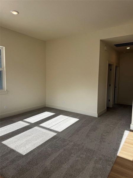 Carpeted empty room featuring recessed lighting and baseboards Carpeted empty room featuring recessed lighting and baseboards