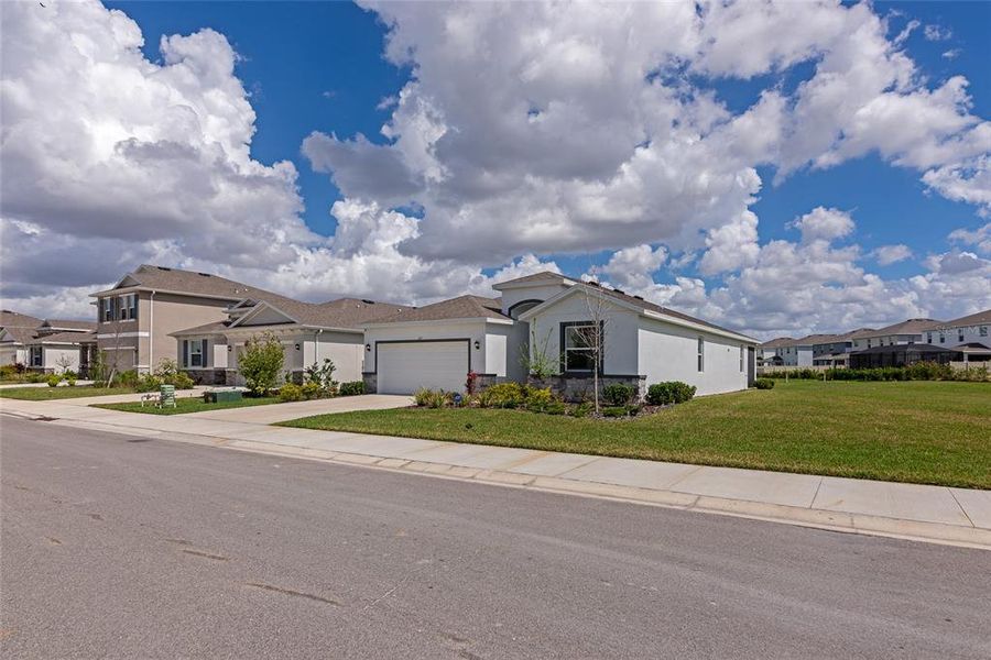 Front exterior of a new home in Coddington, Bradenton, FL, highlighting curb appeal (Image 22).