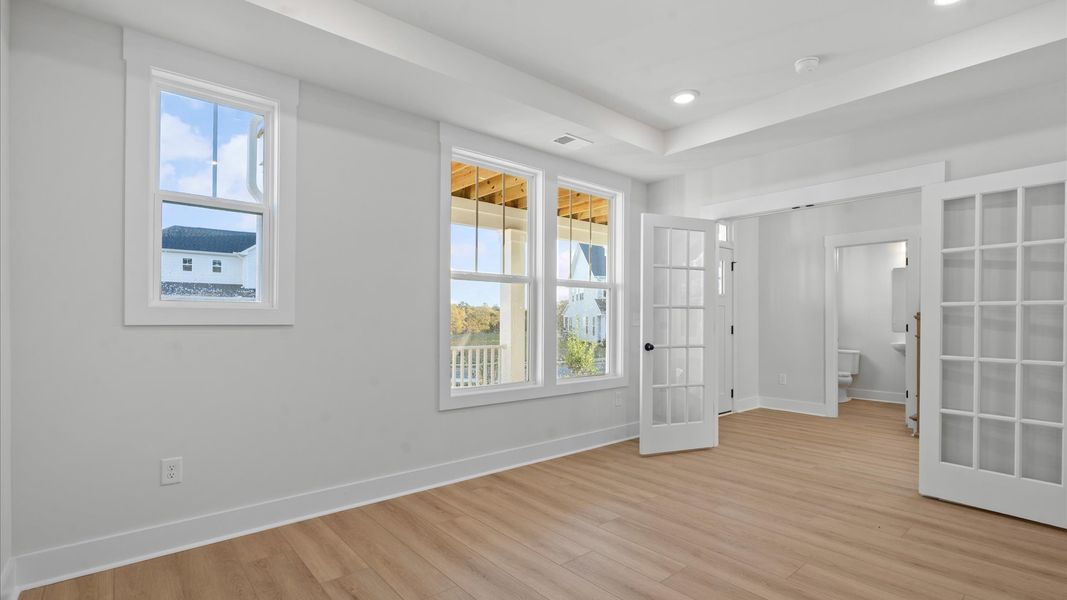 Elegant French door study with tasteful trim and abundant natural light in this first-class DRB Homes design