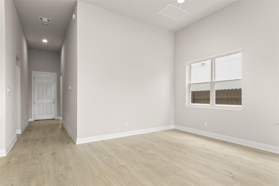 Unfurnished room with light wood-style flooring, recessed lighting, and baseboards