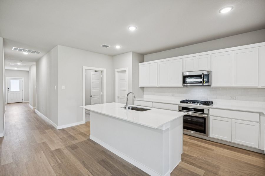 Kitchen in the Oscar home plan by Trophy Signature Homes – REPRESENTATIVE PHOTO Kitchen in the Oscar home plan by Trophy Signature Homes – REPRESENTATIVE PHOTO