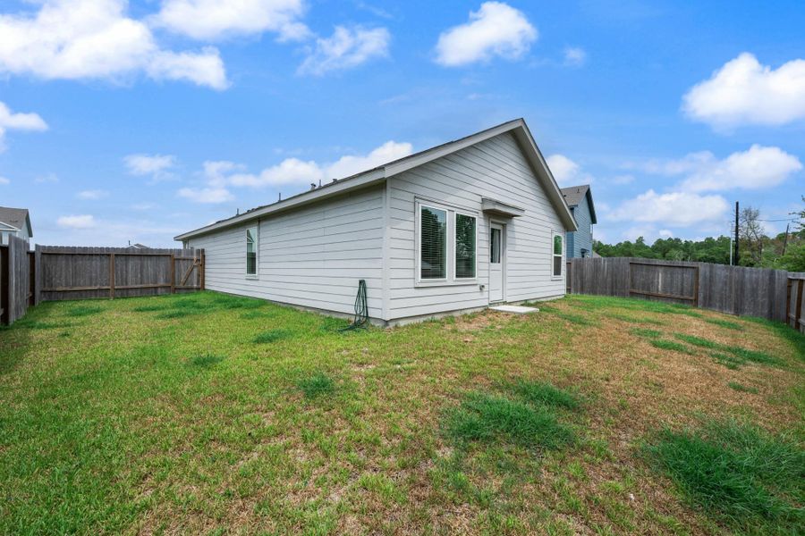 Another perspective showcases the fenced outdoor area and convenient rear entry to the home. Another perspective showcases the fenced outdoor area and convenient rear entry to the home.