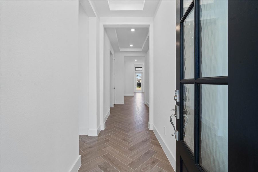 The entryway area is bright and modern, offering a welcoming first impression with tray ceilings, clean lines and stylish finishes.