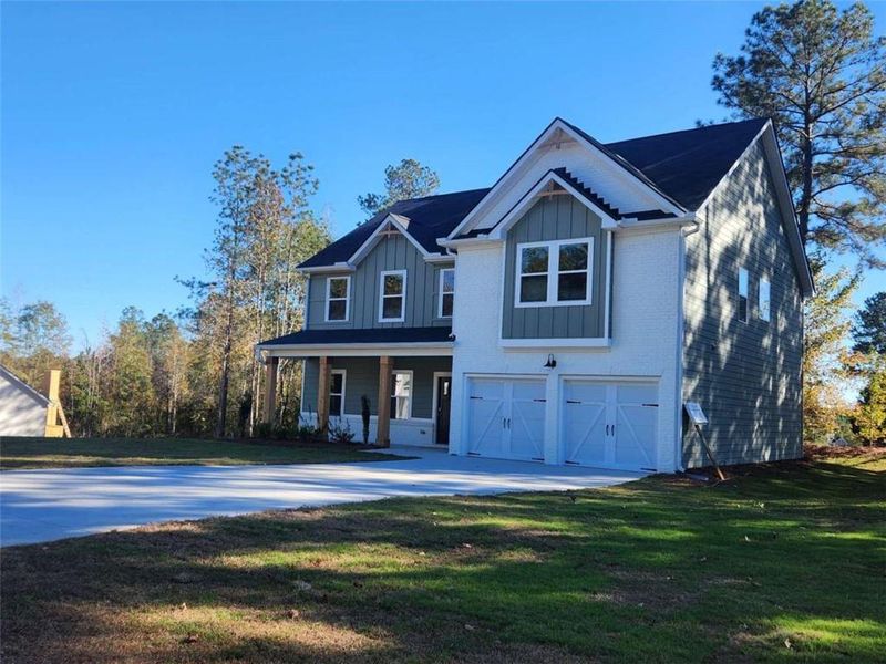 Front exterior of a new home in The Woodlands Preserve, Jackson, GA, highlighting curb appeal (Image 25).