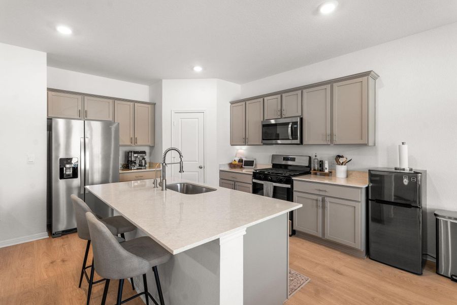Culinary adventures await in this naturally illuminated kitchen with ample counter space and modern appliances. Culinary adventures await in this naturally illuminated kitchen with ample counter space and modern appliances.
